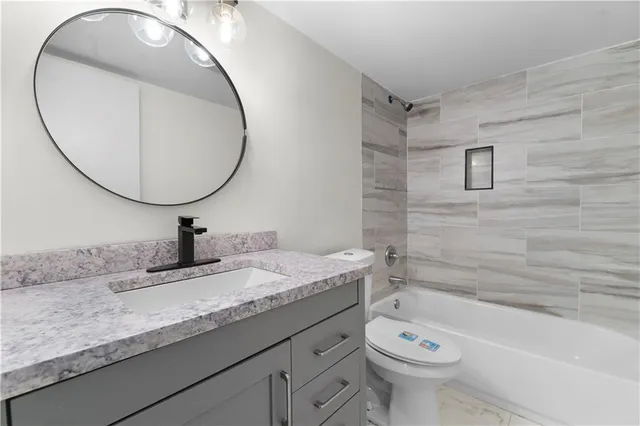 a view of a small space with wooden floor and a window