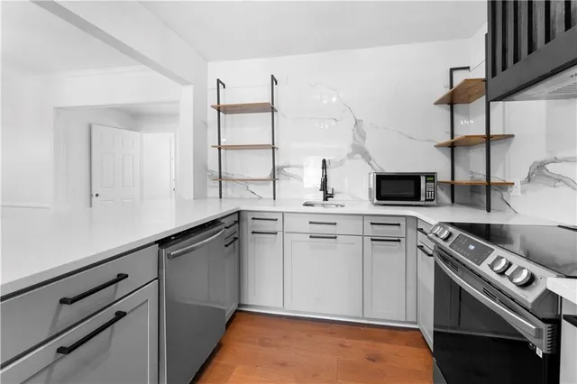 a kitchen with a stove a refrigerator and a sink