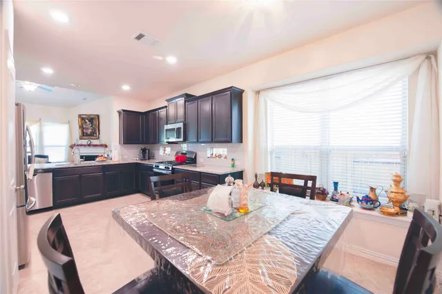 a large kitchen with a table and chairs in it