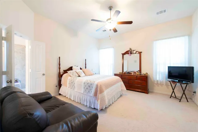 a bedroom with bed and a chandelier