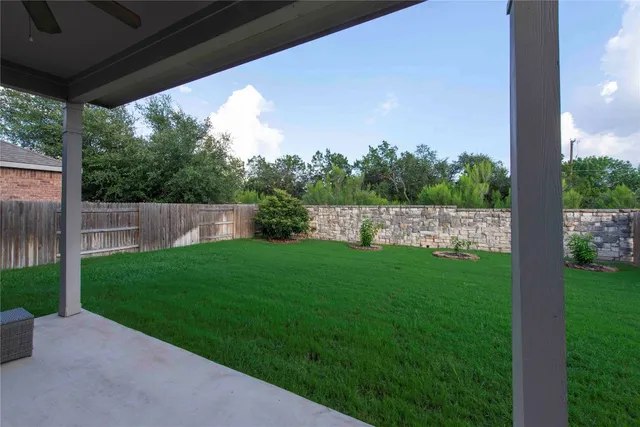 a view of a house with backyard and porch