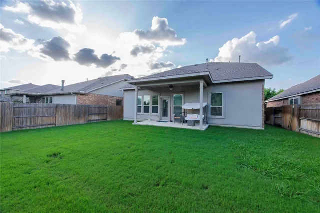 a view of a porch with a table and chairs