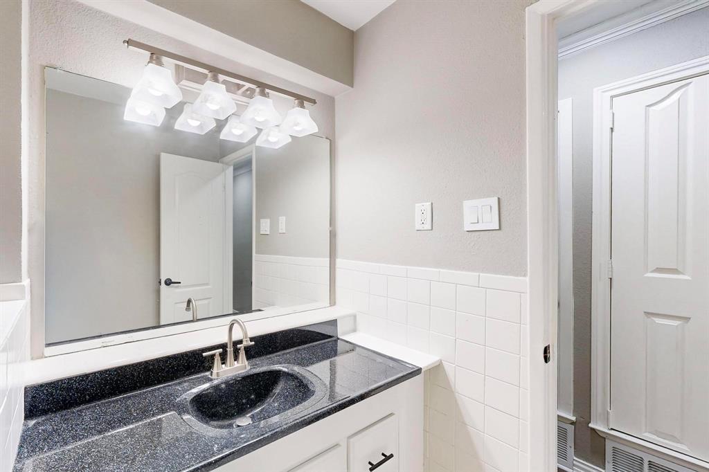 3264 Northaven Road Dallas, TX 75229 - Photo 21 of 35 Bathroom featuring vanity and tile walls