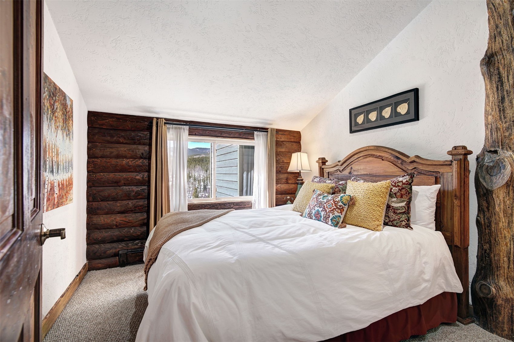 9460 Ryan Gulch Road, Unit 9460 Silverthorne, CO 80498 - Photo 18 of 39 a bedroom with a bed and a large mirror