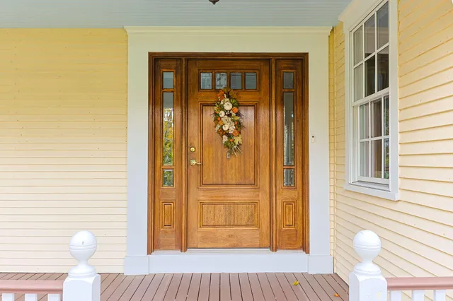 a view of a dining room with furniture a chandelier and wooden floor