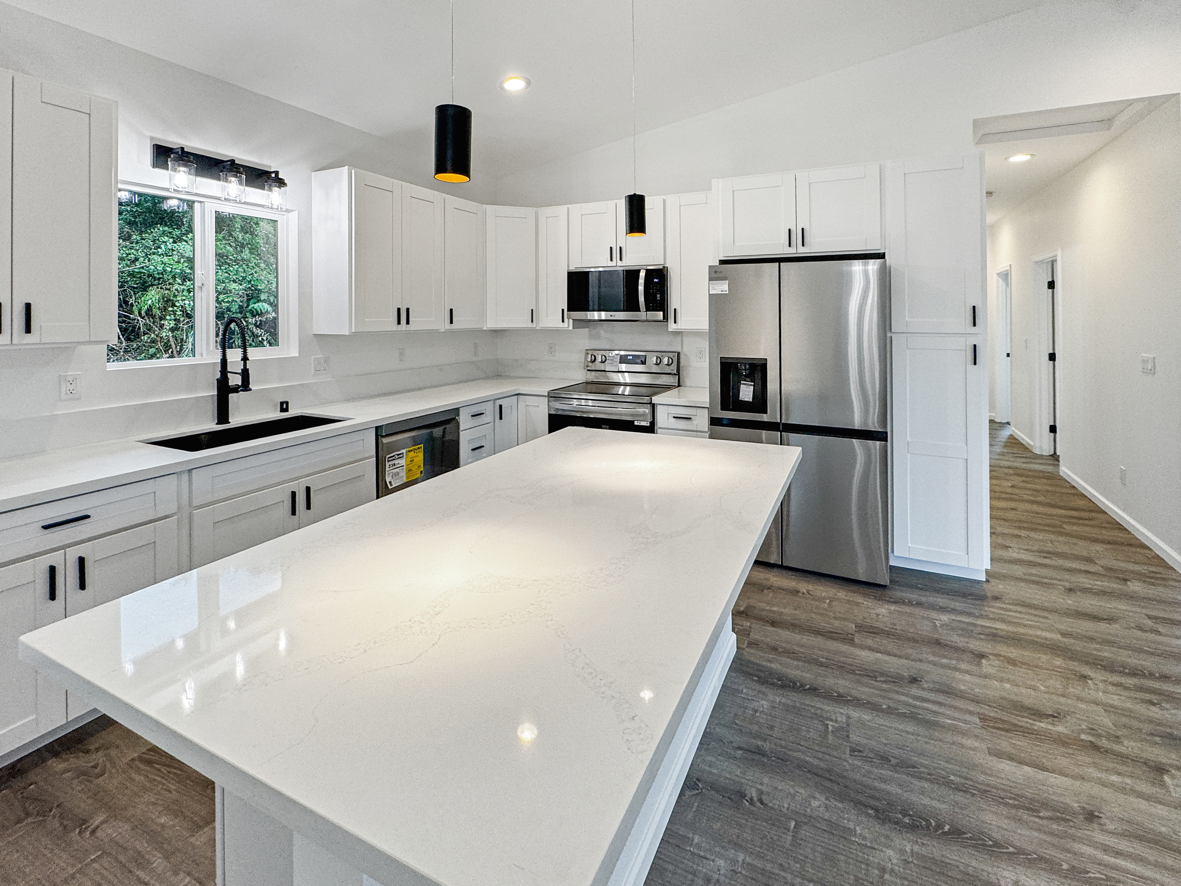 18-7846 Leonaka Road Mountain View, HI 96771 - Photo 4 of 13 a kitchen with sink a refrigerator and wooden cabinets