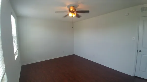 a view of room with a ceiling fan and window