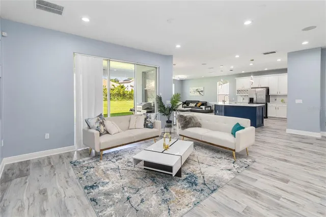 a living room with furniture and a large mirror
