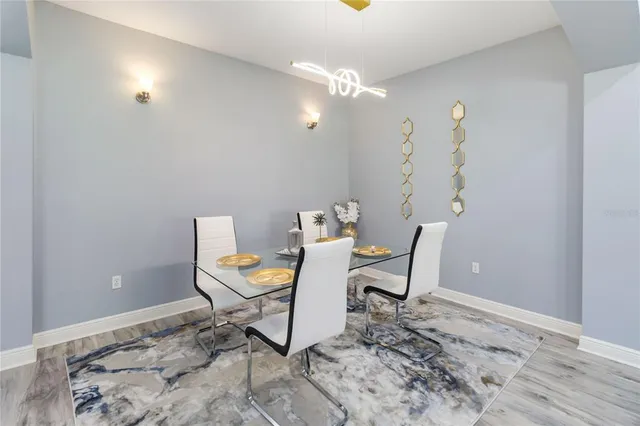 a large kitchen with stainless steel appliances a large counter top a sink a refrigerator and a refrigerator