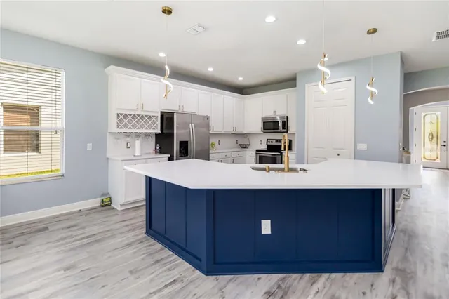 a large kitchen with a table and chairs