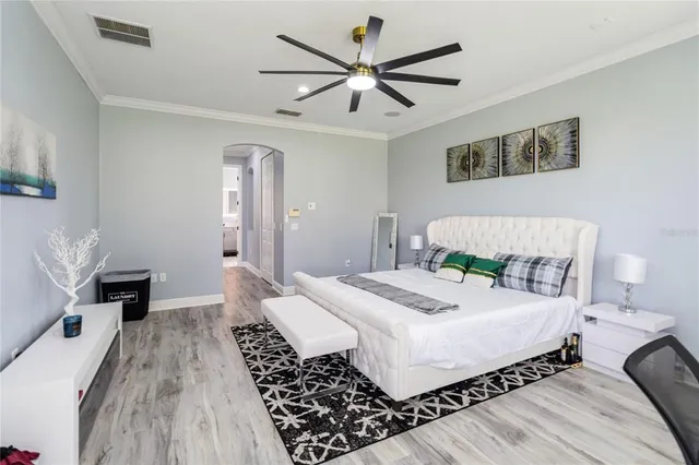 a bedroom with a large bed and a window