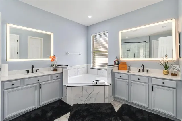 a bathroom with a double vanity sink a mirror and shower