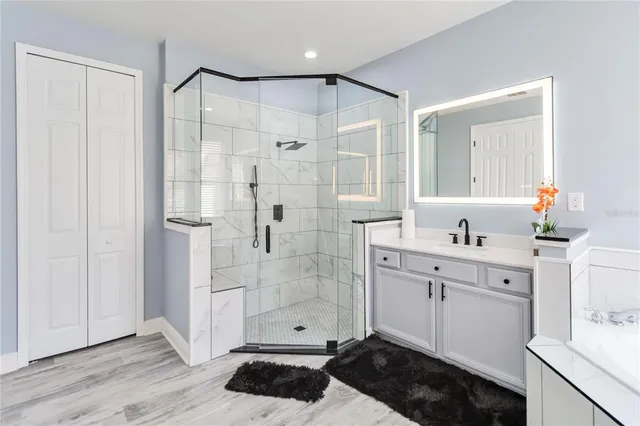 an empty room with windows chandelier fan and windows