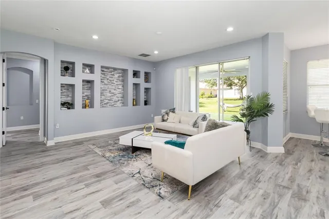 a living room with furniture and a large window