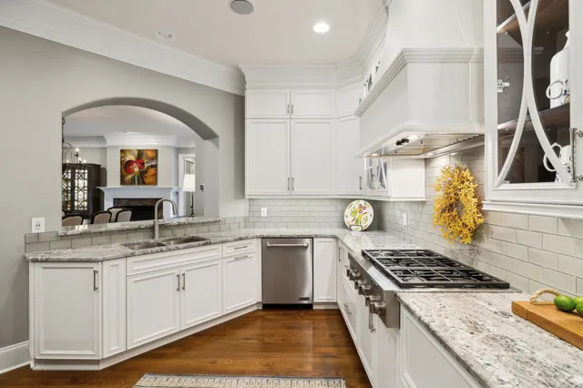 a kitchen with stainless steel appliances granite countertop a stove and a sink