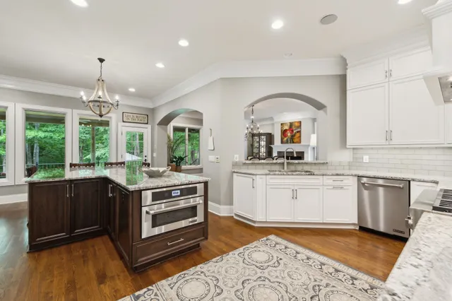 a view of a kitchen counter top space with a sink and wooden floor