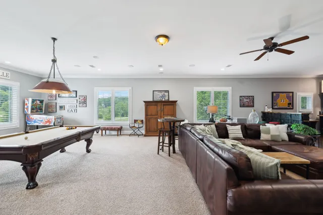 a bedroom with a bed a window and a chandelier