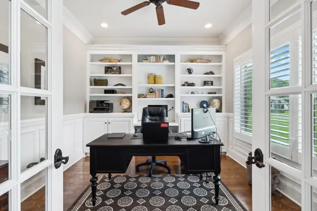 a view of a dining room with furniture a chandelier and wooden floor