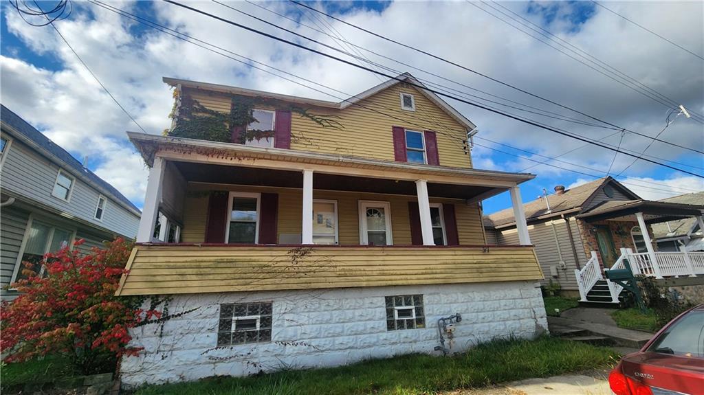 a view of a house with a yard and balcony