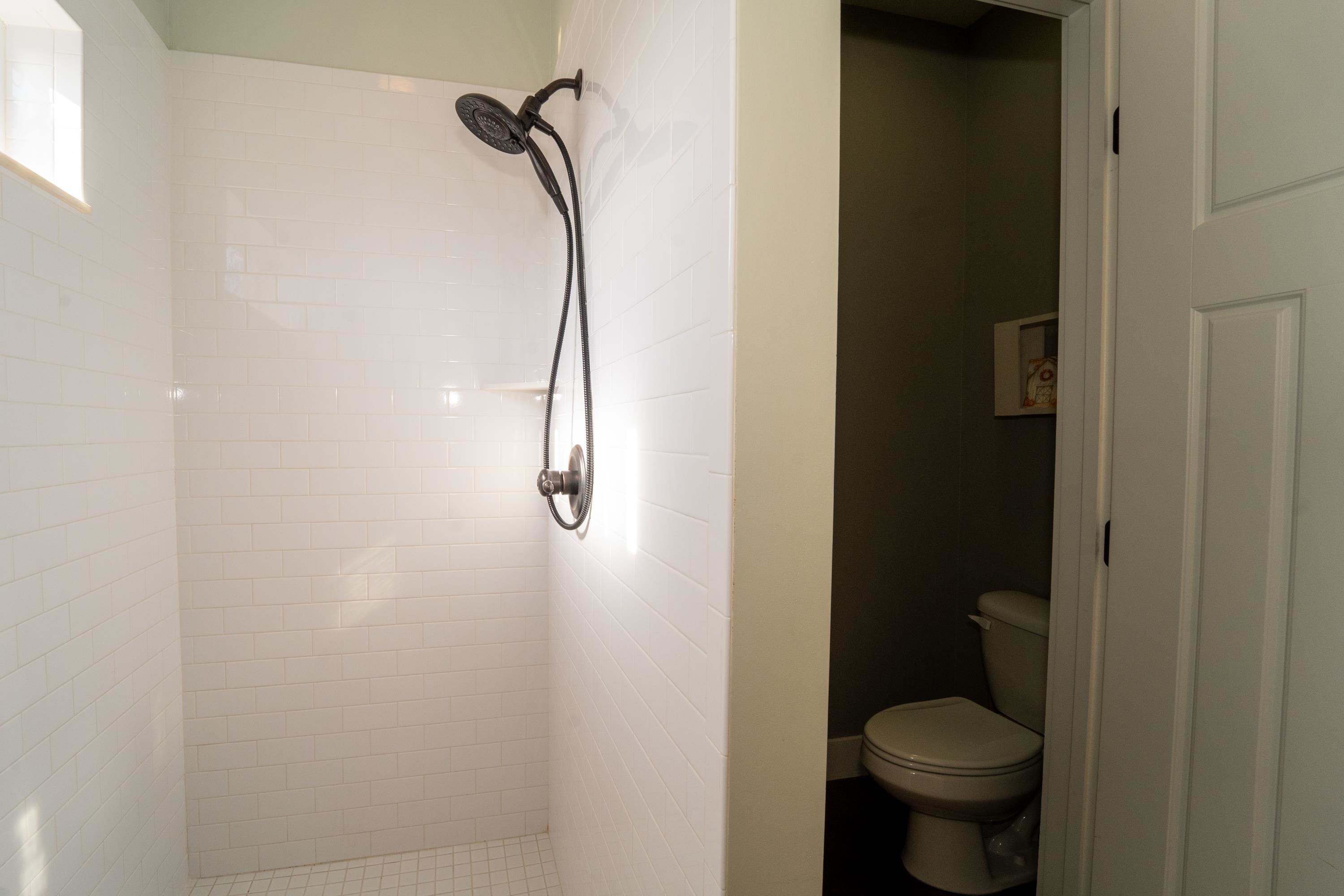 228 Herada Street St. Augustine, FL 32080 - Photo 25 of 32 a bathroom with a granite countertop toilet and a shower