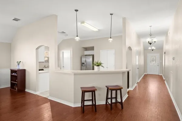 a view of a dining room with furniture and wooden floor
