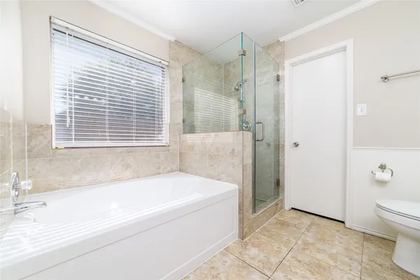 a white bath tub sitting next to a toilet