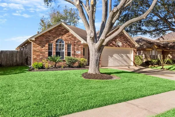 a front view of house with a garden