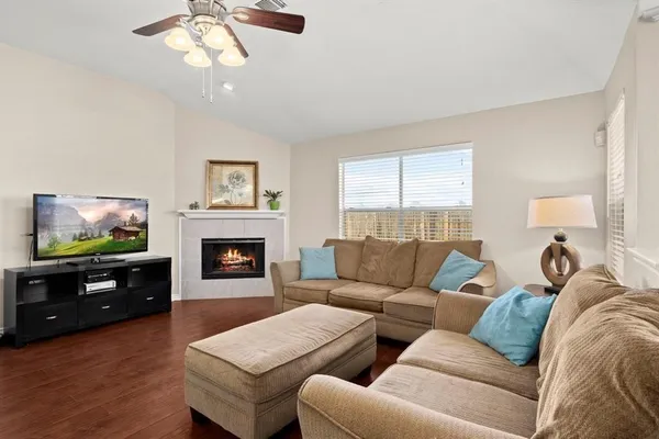 a living room with furniture and a fireplace