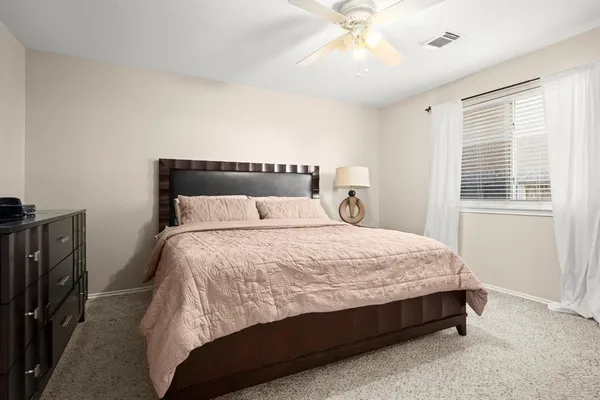 a bed sitting in a bedroom next to a window