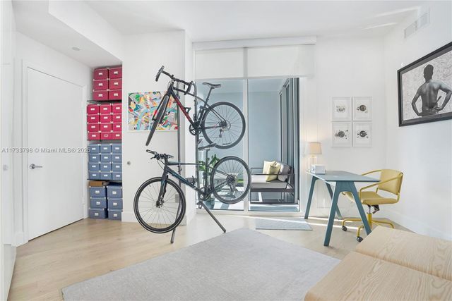 a bedroom with a bed and a large window