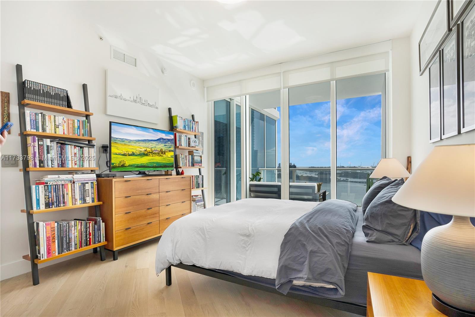 2020 North Bayshore Drive, Unit 2302 Miami, FL 33137 - Photo 30 of 57 a bedroom with a bed furniture and a book shelf