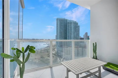 a front view of a house with garden and houses