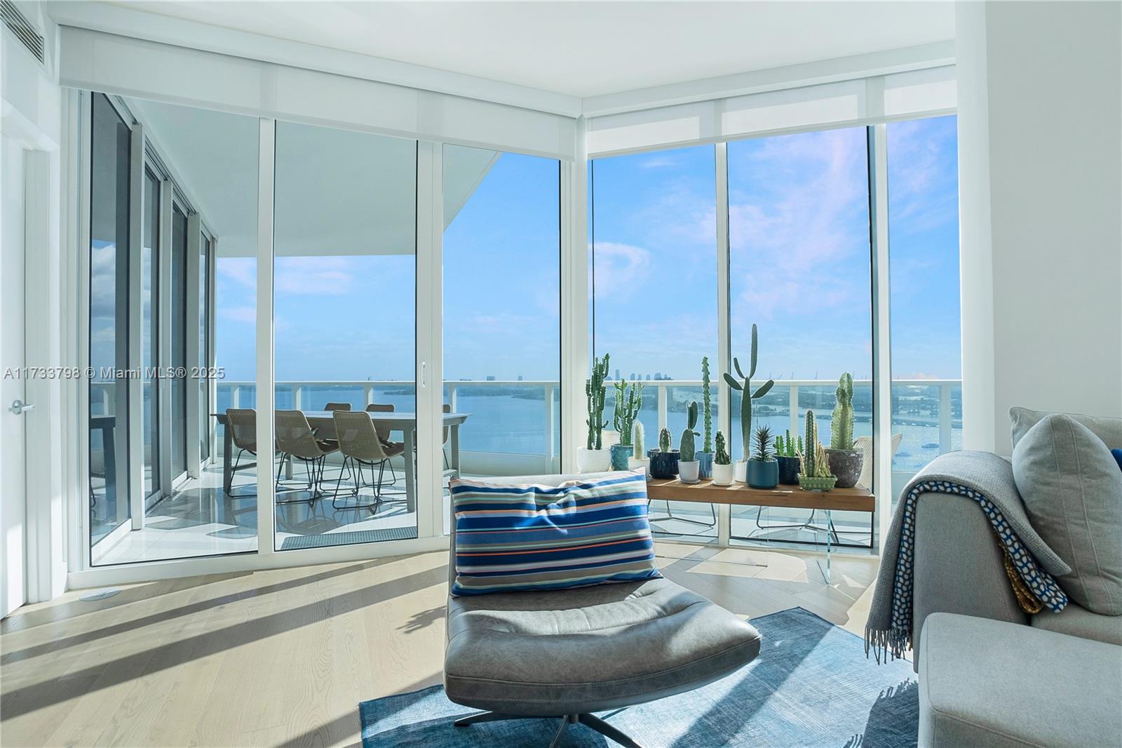 2020 North Bayshore Drive, Unit 2302 Miami, FL 33137 - Photo 8 of 57 a living room with furniture and a floor to ceiling window