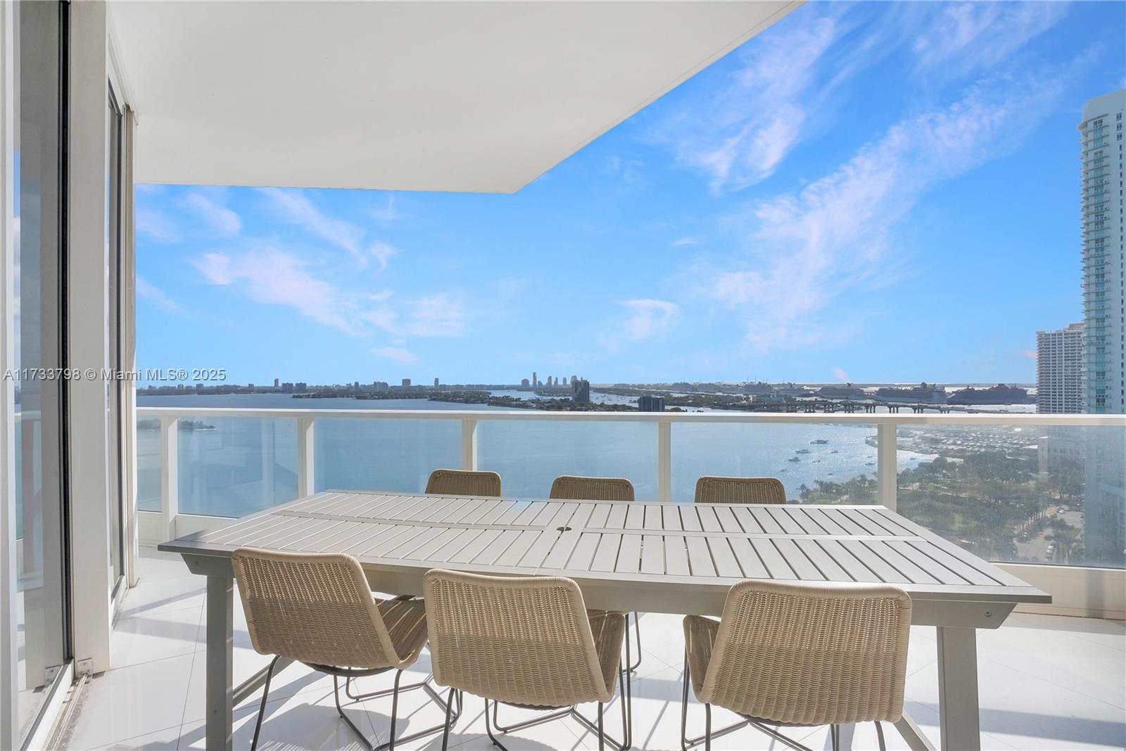 2020 North Bayshore Drive, Unit 2302 Miami, FL 33137 - Photo 9 of 57 a view of a lake with table and chairs