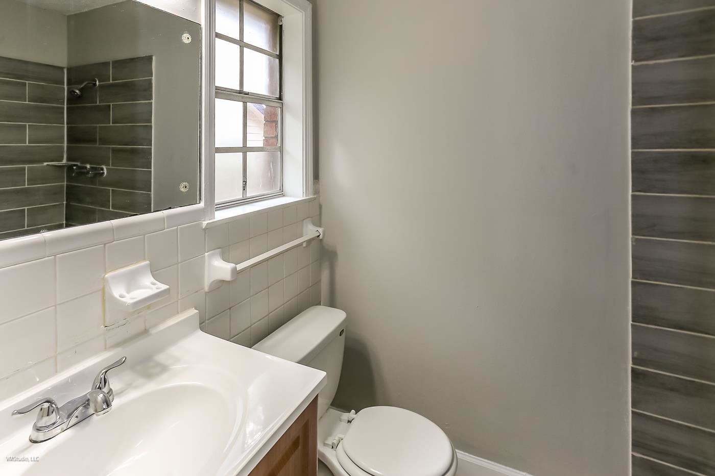 5217 Yale Road Memphis, TN 38134 - Photo 16 of 30 Bathroom with vanity, toilet, decorative backsplash, and tile walls