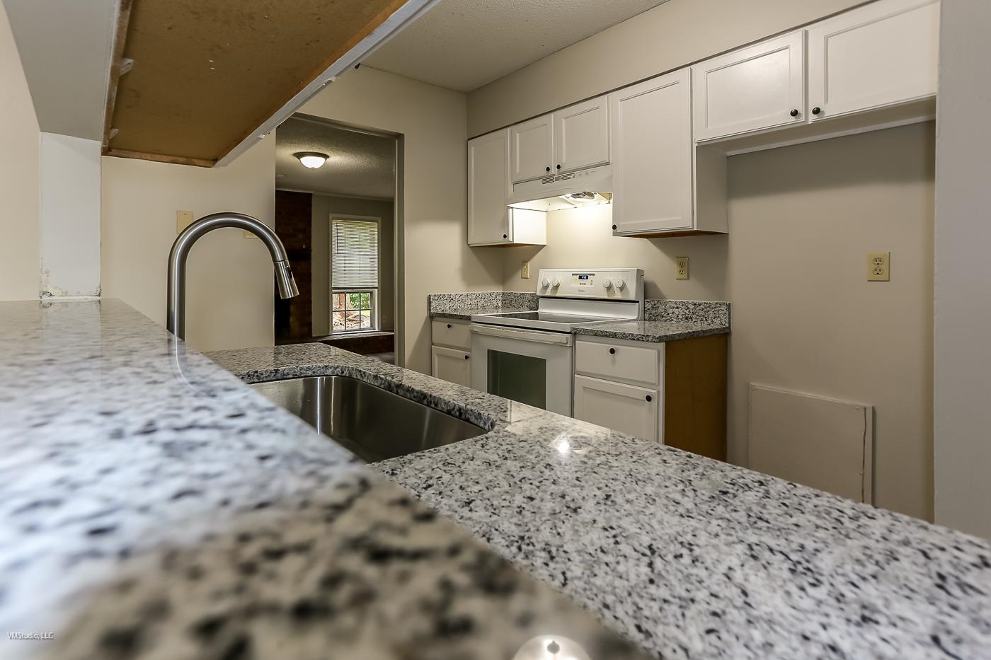 5217 Yale Road Memphis, TN 38134 - Photo 29 of 30 Kitchen featuring sink, white electric range, white cabinets, and light stone counters