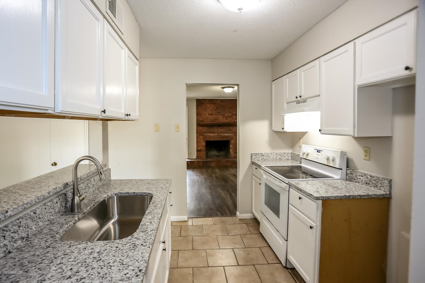 5217 Yale Road Memphis, TN 38134 - Photo 6 of 30 Kitchen featuring light hardwood / wood-style flooring, white electric range, white cabinets, light stone countertops, and sink