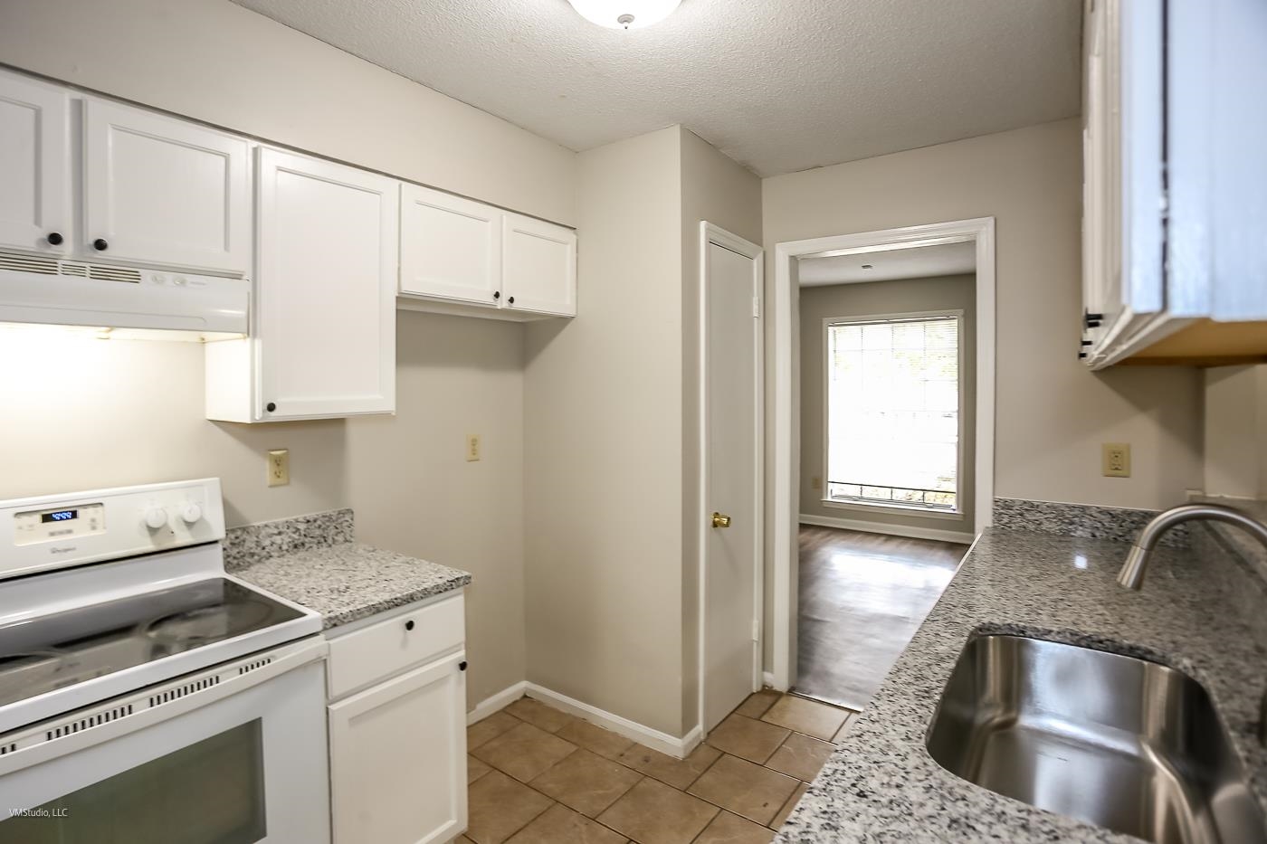 5217 Yale Road Memphis, TN 38134 - Photo 7 of 30 Kitchen featuring sink, white cabinets, white electric range oven, and light tile patterned floors