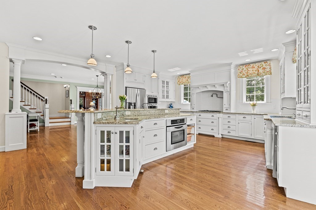 3 Ordway Road Wellesley, MA 02481 - Photo 16 of 38 a large kitchen with stainless steel appliances kitchen island granite countertop a large center island a stove a sink a refrigerator and a living room view