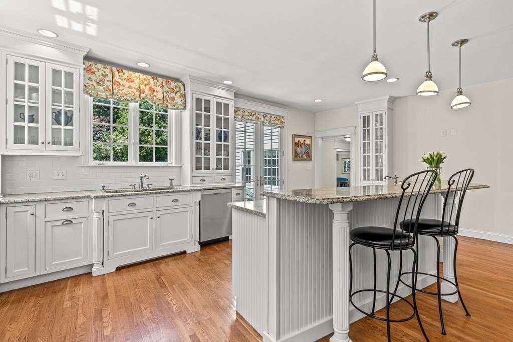 3 Ordway Road Wellesley, MA 02481 - Photo 18 of 38 a very nice looking kitchen with granite countertop a stove two sinks and a chandelier