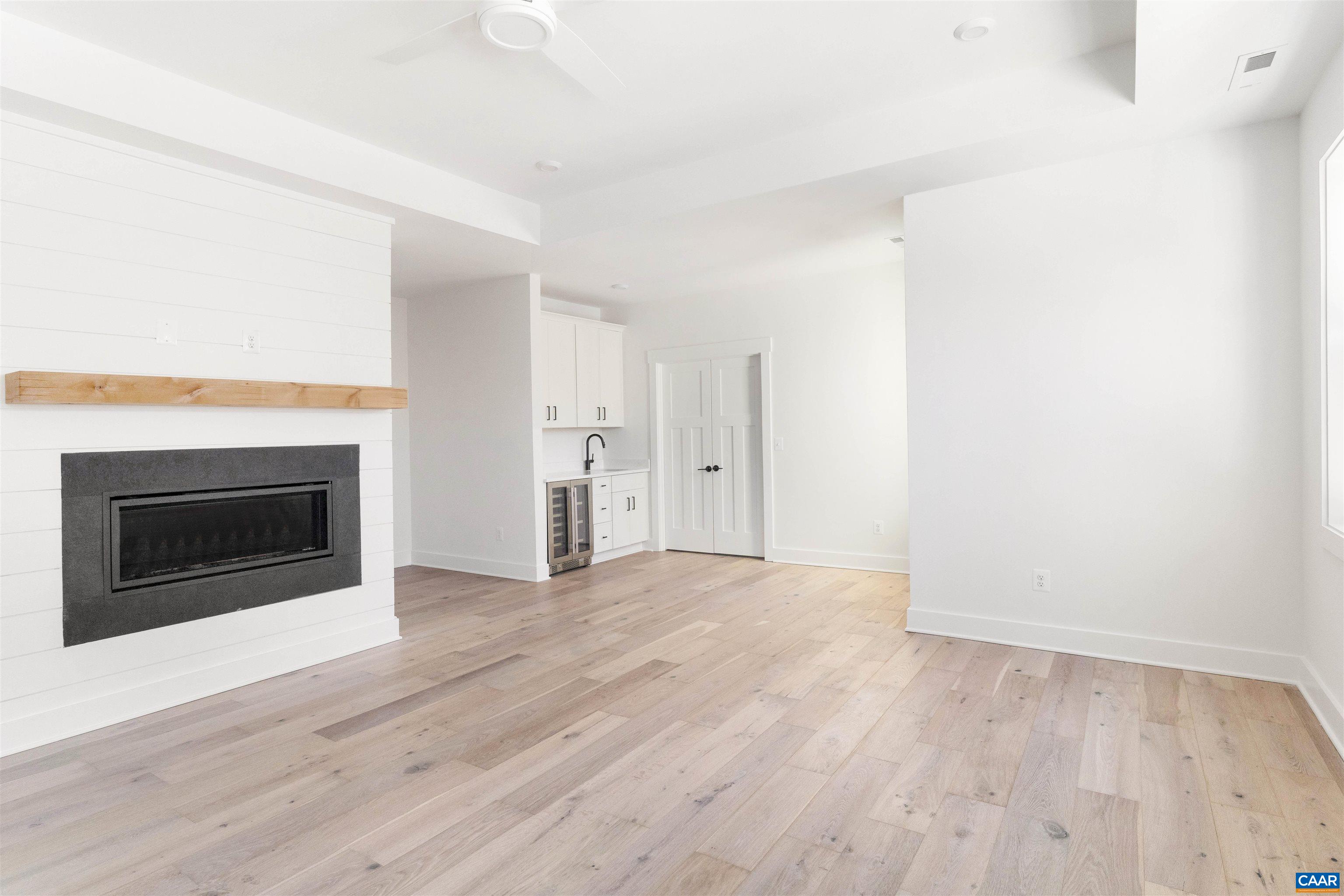 1000 Broad Axe Road Charlottesville, VA 22903 - Photo 32 of 58 a view of empty room with wooden floor and fireplace