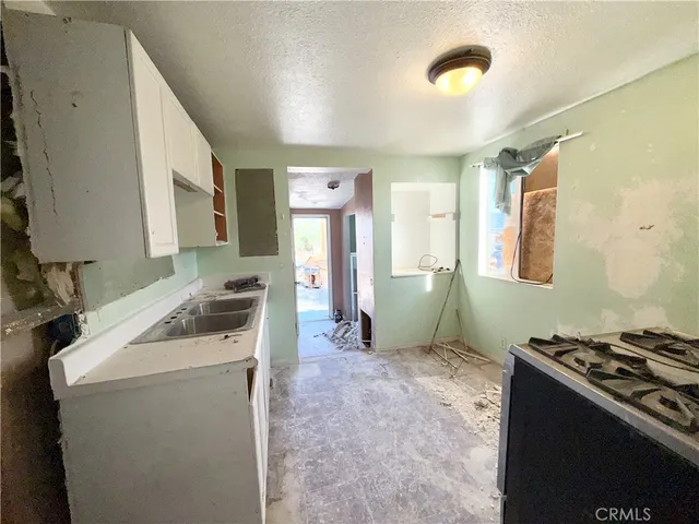 a kitchen with stainless steel appliances granite countertop a sink and a refrigerator