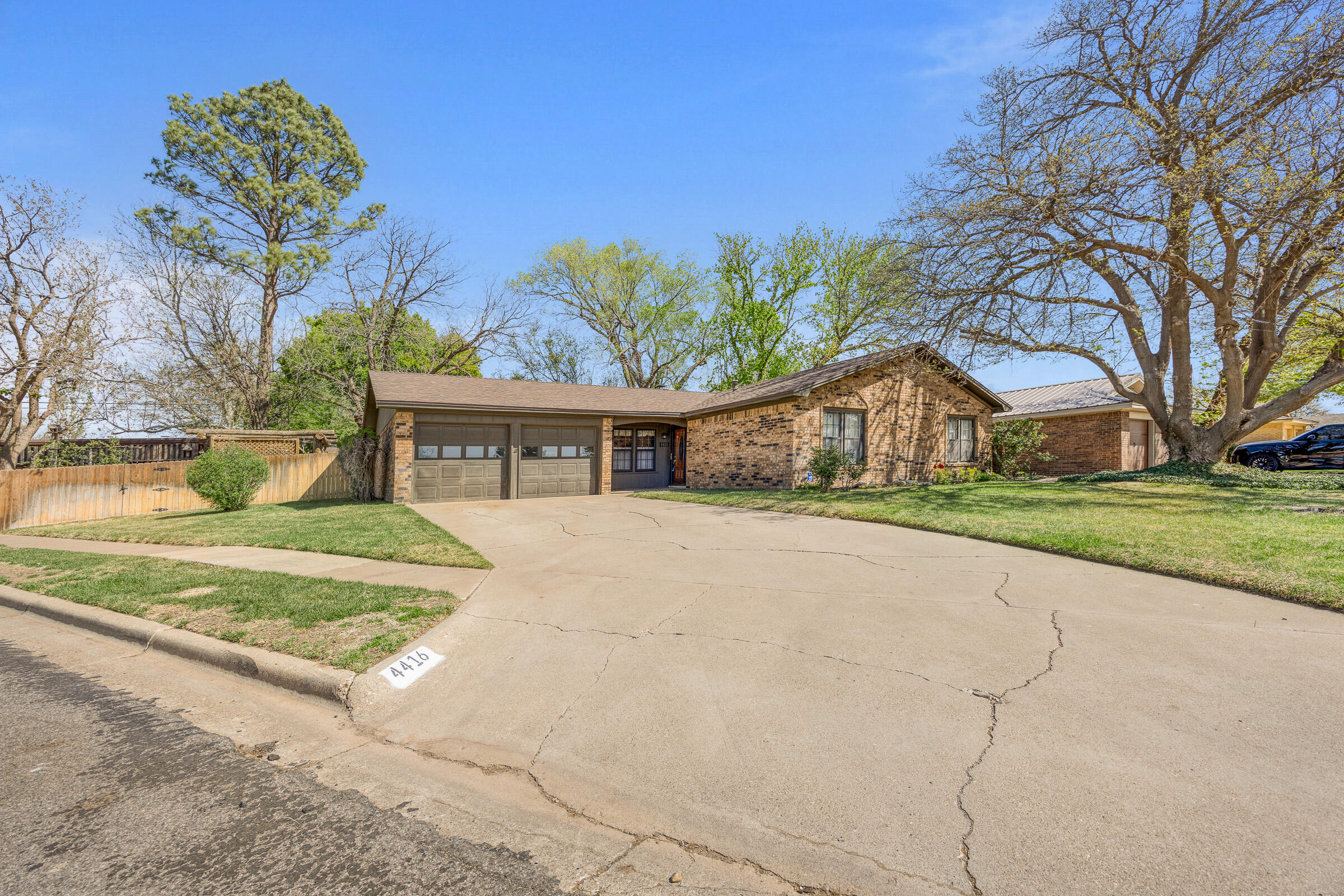 4416 62nd Street Lubbock, TX 79414 - Photo 2 of 70 a front view of house with yard and trees in the background