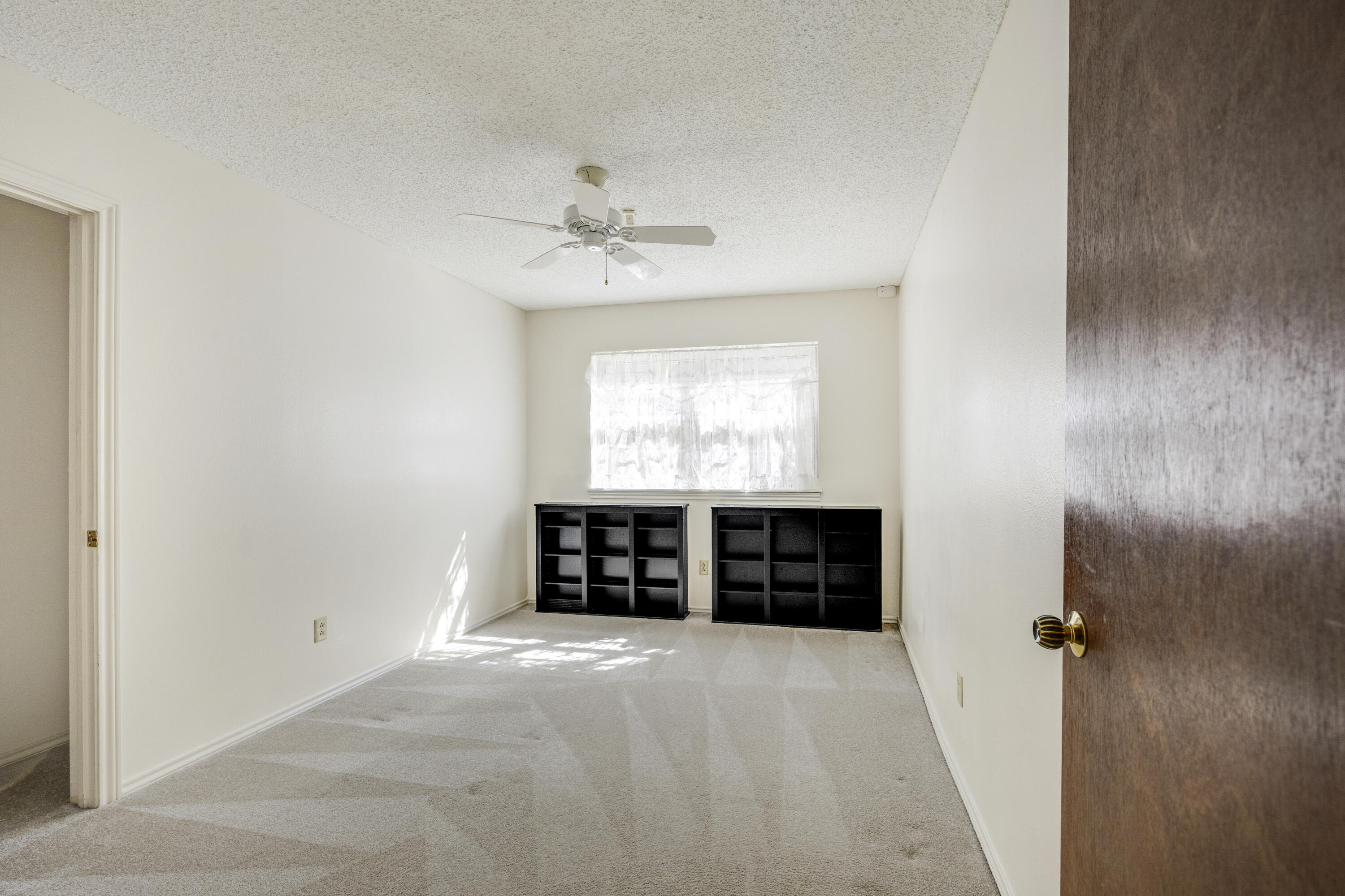 4416 62nd Street Lubbock, TX 79414 - Photo 22 of 70 an empty room with a fireplace and window
