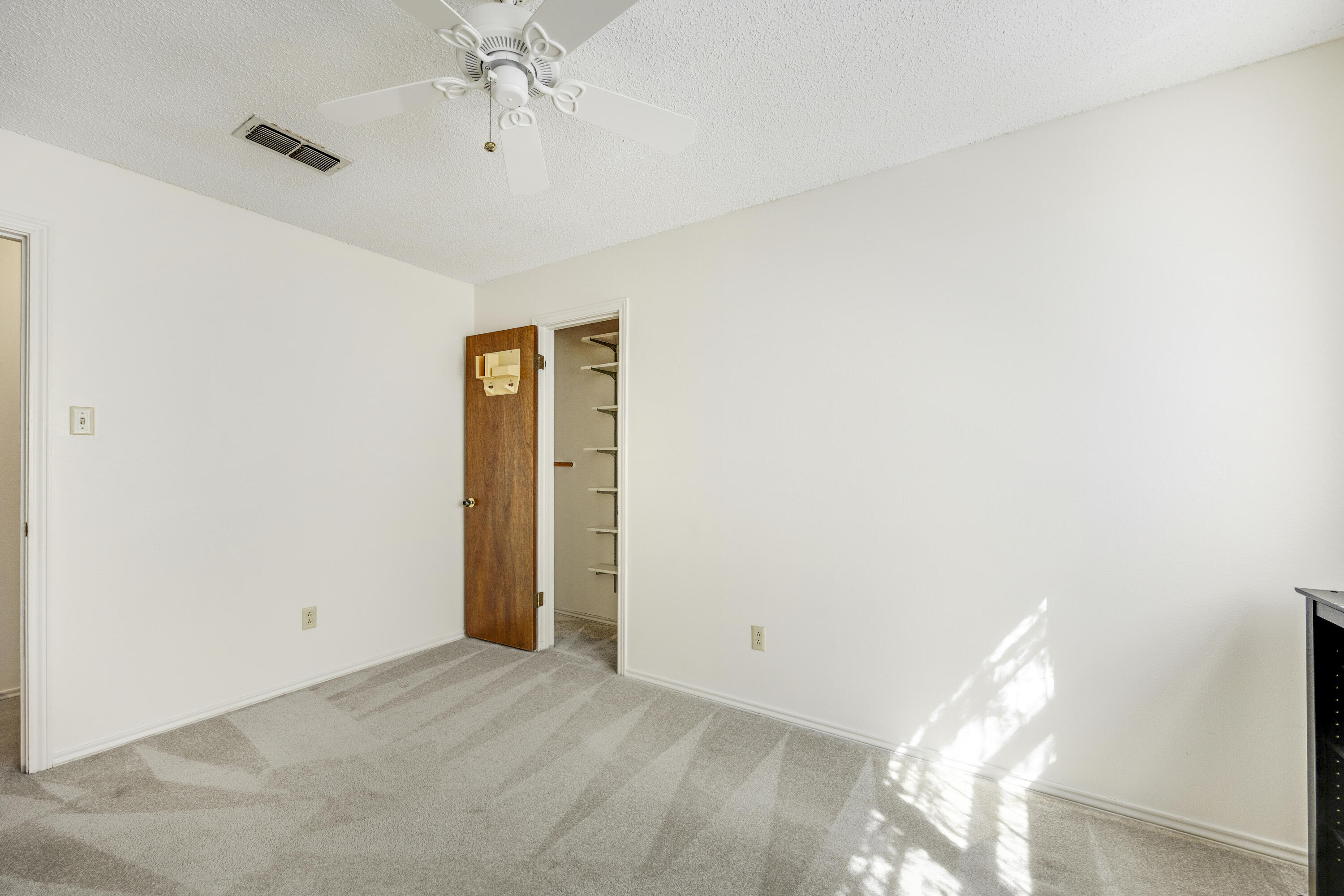 4416 62nd Street Lubbock, TX 79414 - Photo 23 of 70 a view of a hallway with a chandelier fan