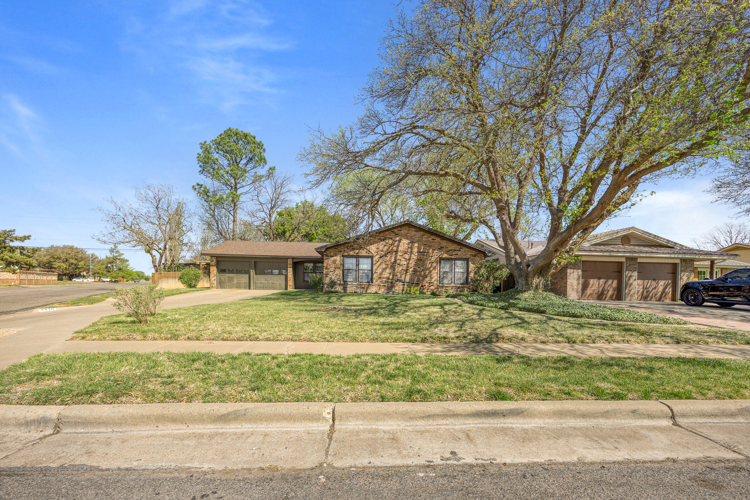 4416 62nd Street Lubbock, TX 79414 - Photo 3 of 70 a front view of a house with a garden