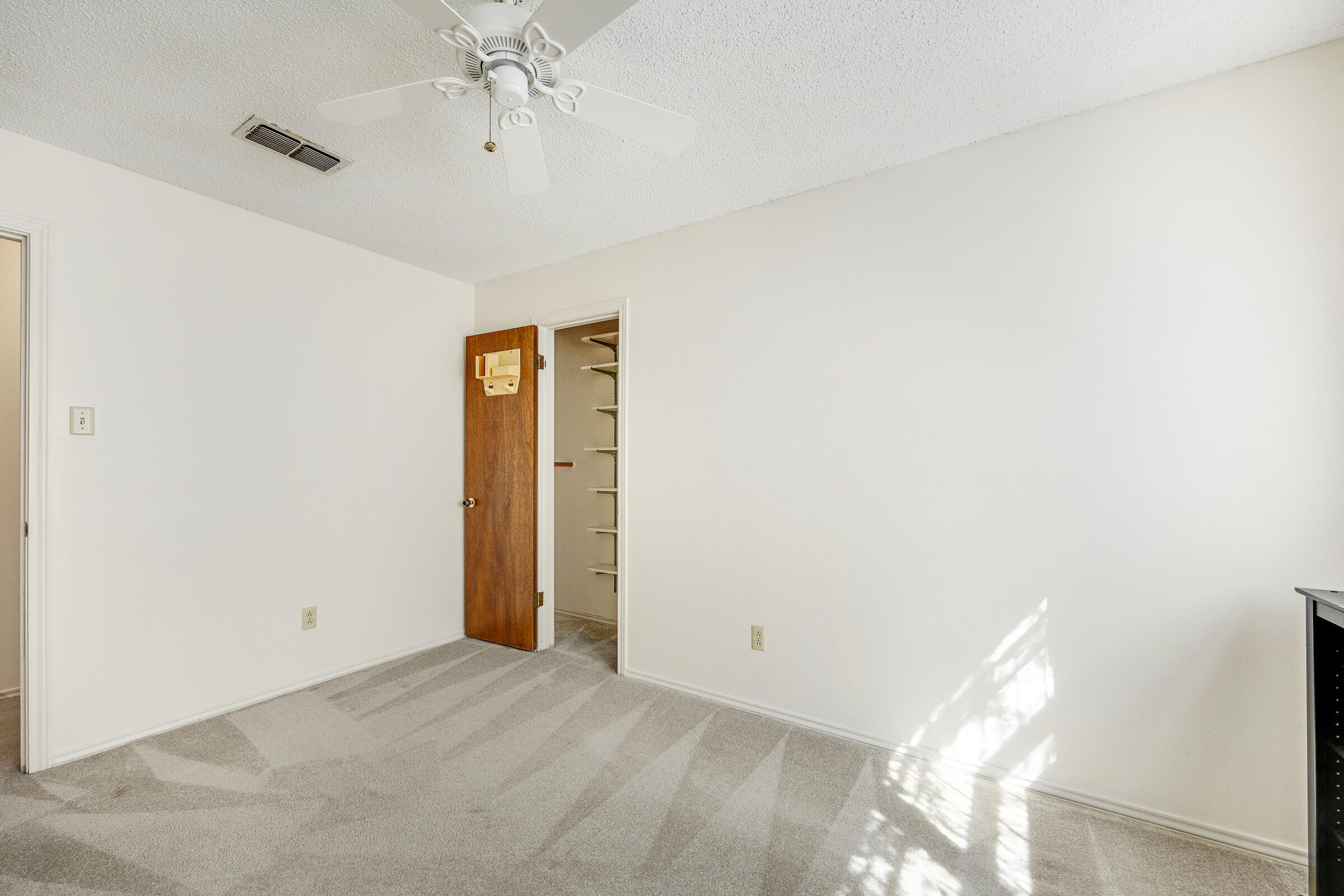 4416 62nd Street Lubbock, TX 79414 - Photo 31 of 70 a view of a hallway with a chandelier fan