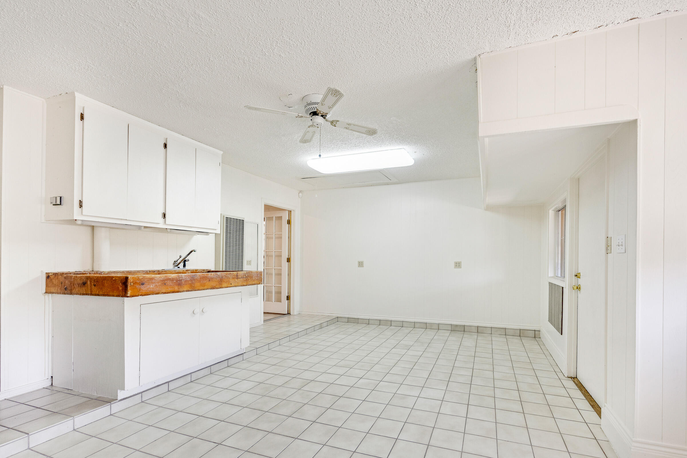 4416 62nd Street Lubbock, TX 79414 - Photo 36 of 70 a view of a kitchen with a sink and dishwasher with white cabinets