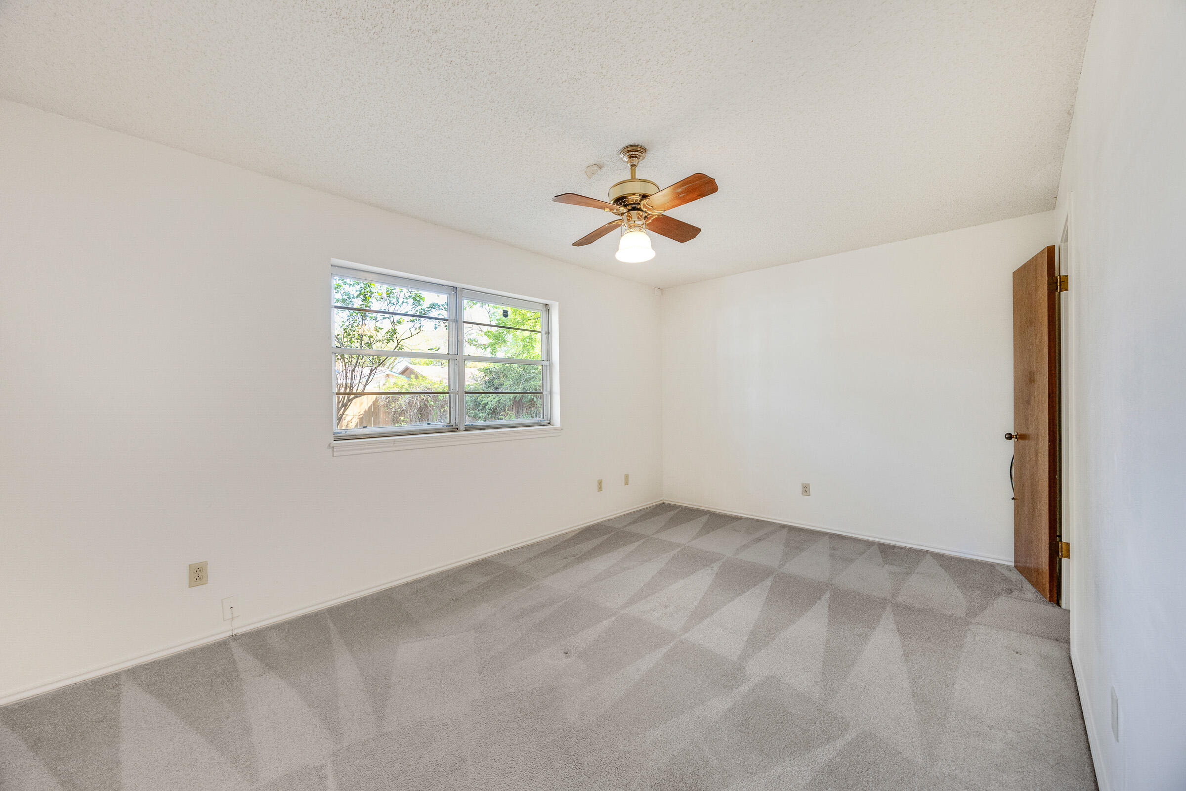 4416 62nd Street Lubbock, TX 79414 - Photo 40 of 70 an empty room with windows and a chandelier fan