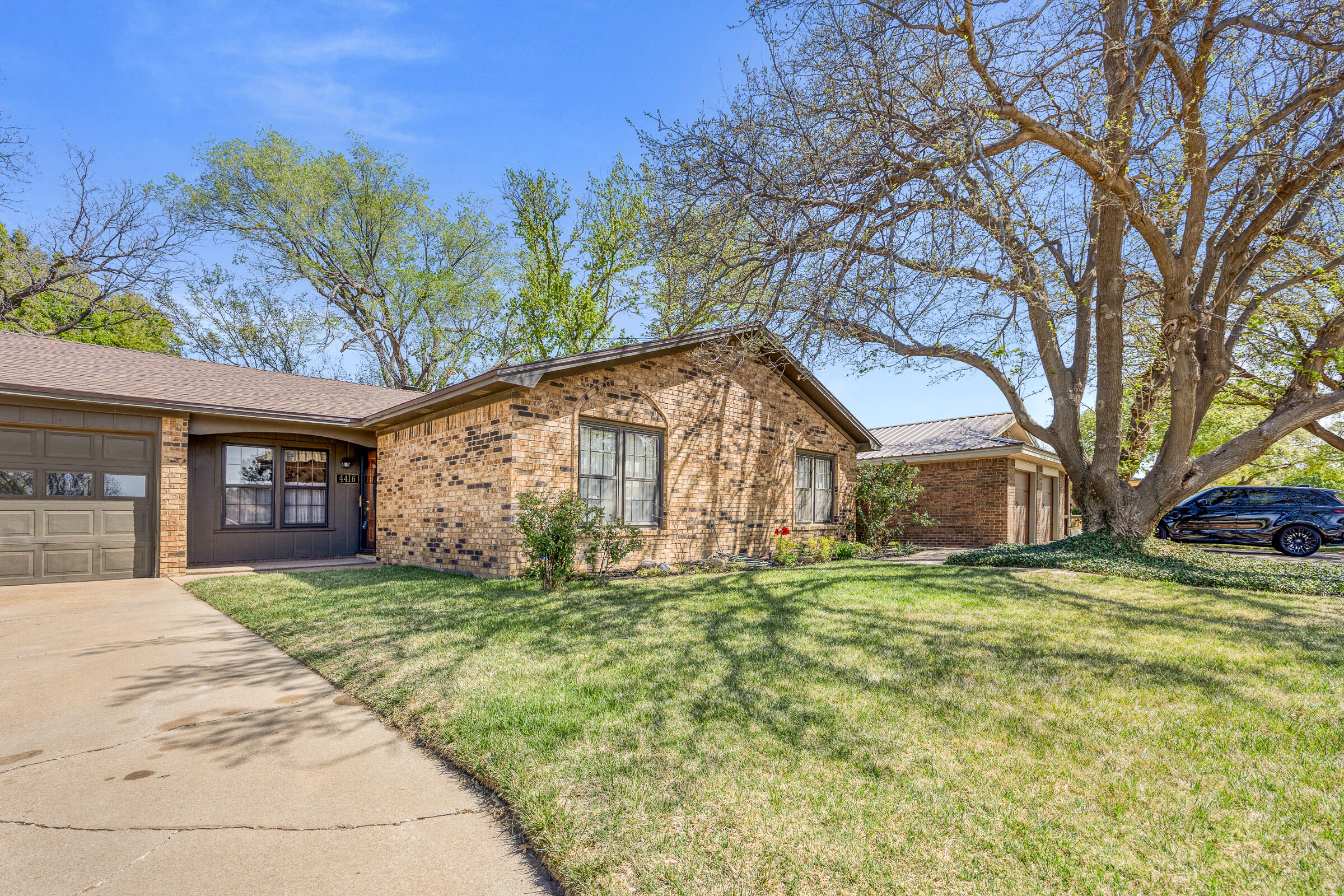 4416 62nd Street Lubbock, TX 79414 - Photo 4 of 70 a view of a house with a yard